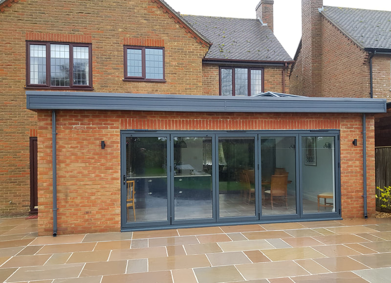 A single-storey extension with flat roof and roof light.